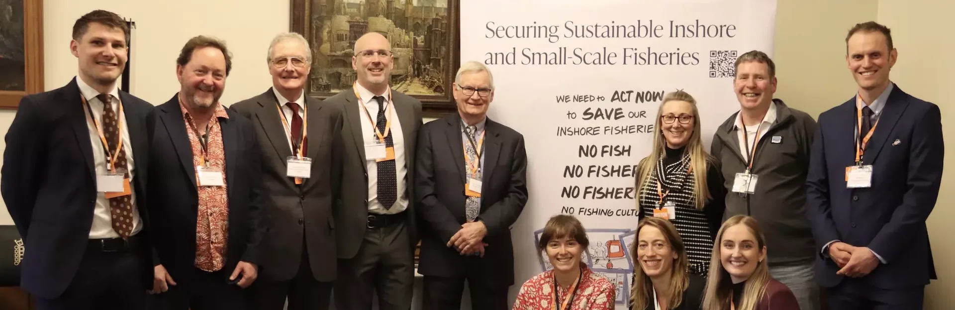 Inshore and Small-Scale Fisheries partners at the Parliamentary event in March 2025, including colleagues from Newcastle University, Marine Biological Association, Association of Inshore Fisheries and Conservation Authorities, Blue Marine Foundation, Scottish Creel Fishermen’s Federation and Whitby Lobster Hatchery in front of a banner promoting sustainable inshore and small-scale fisheries.